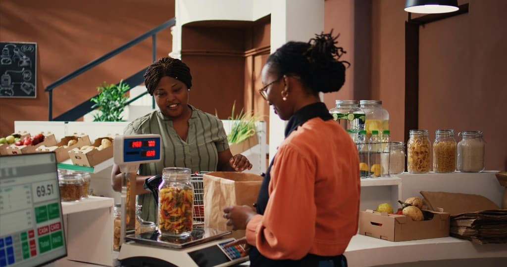 Customer and cashier at a sustainable grocery checkout counter