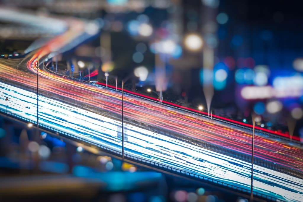 Long-exposure light trails representing fast programmatic settlement